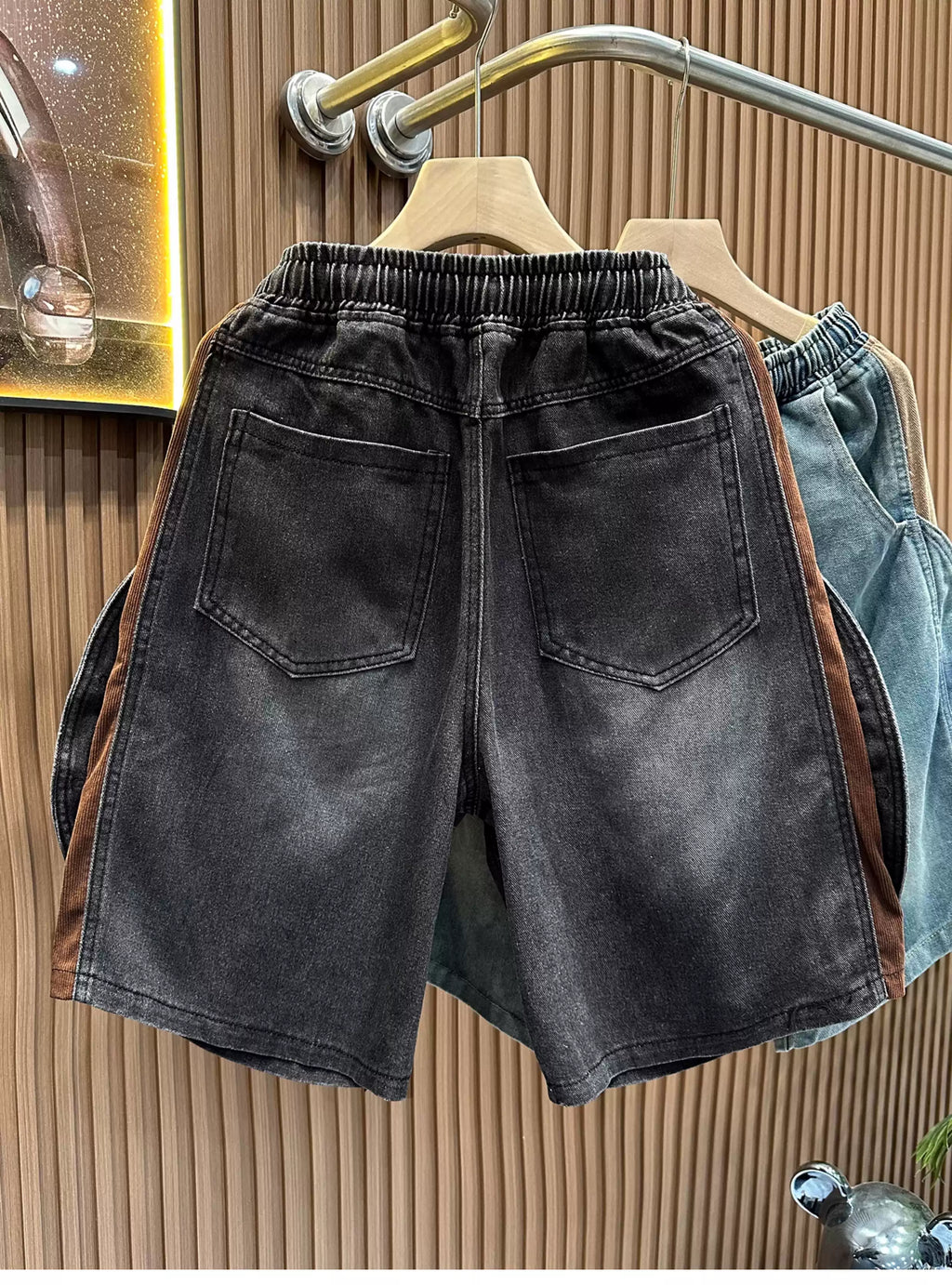 Rear view of the Common Theory Vintage Panel Denim Shorts in dark vintage grey, highlighting the relaxed fit, two rear patch pockets, and contrast brown corduroy side paneling.