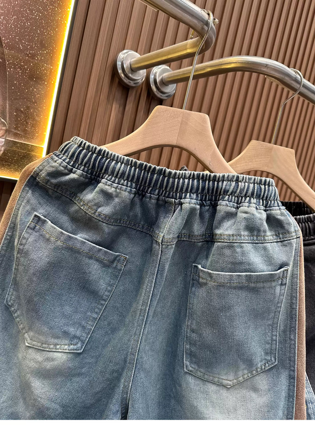Rear view of the Common Theory Vintage Panel Denim Shorts in vintage blue, highlighting the relaxed fit, two rear patch pockets, and contrast brown corduroy side paneling.